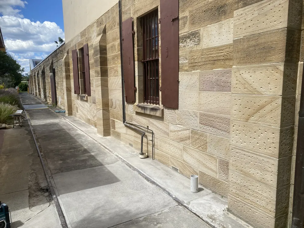 Restored sandstone building with shuttered windows